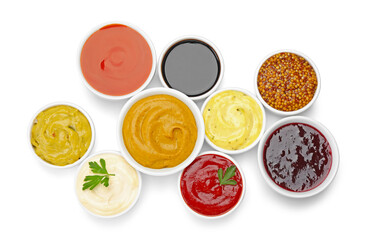Different sauces in bowls isolated on white, top view