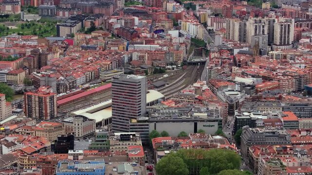 High-altitude tripod view of Bilbao, Spain highlights city's urban scenery, mix of residential structures and prominent train station