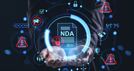 Businessman holding holographic NDA agreement concept with security, mute, and legal icons on dark digital background representing non-disclosure policy.