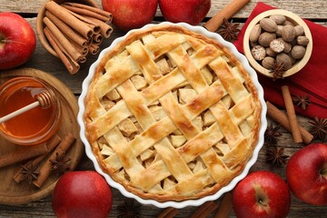 Tasty homemade apple pie and ingredients on wooden table, flat lay