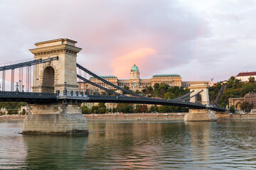 Fototapeta premium The 1849&nbsp;Széchenyi Chain Bridge over the Danube River, with the 14th Century Buda Castle in the background seen during a spectacular pink sunrise, Budapest, Hungary
