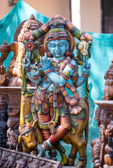Colorful handmade idol of hindu god krishna in decorated pandal for worship during the ganesh chaturthi festival.