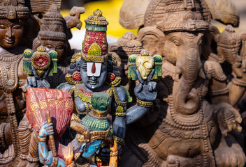 Wooden art, Handmade wooden idol on lord tirupati at surajkund craft fair. Selective focus.