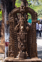 Wooden art, Handmade wooden idol on lord tirupati at surajkund craft fair. Selective focus.