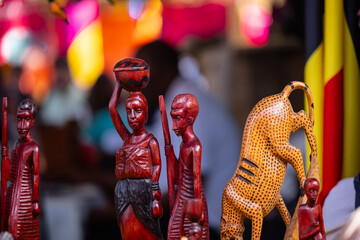 Handmade tribal people of africa souvenir idol from african artist on display at surajkund craft fair for sale. Selective focus.