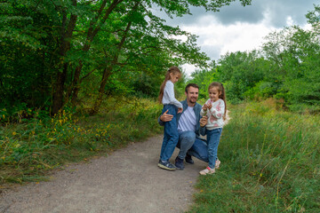 Fototapeta premium Father and children have fun, laugh and enjoy nature outdoors.