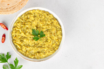 Indian khichdi, kichari with rice, mung bean groats with roti on white background. Top view. Ayurveda diet. Indian food.
