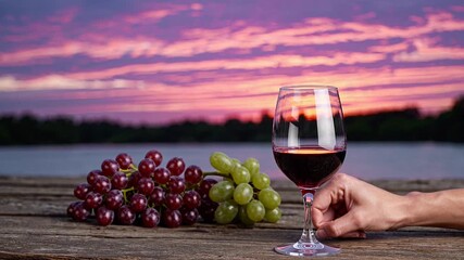 Sunset paints sky in soft hues, calm evening invites relaxation, calm atmosphere enhanced by red wine, calm moment captured with wine glass in hand, calm beauty of nature meets wine elegance