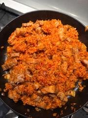 Kimchi fried rice with pork in a frying pan.