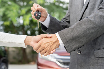 lease, rental car, sell, buy. Dealership shake hand customer for new Car. Sales, loan credit...