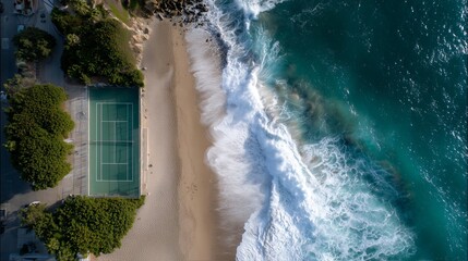 Fototapeta premium Aerial view of a coastal tennis court near crashing waves at sunset
