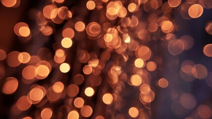 Soft, circular highlights of amber and gold against a dark background, creating a blurry, abstract light effect