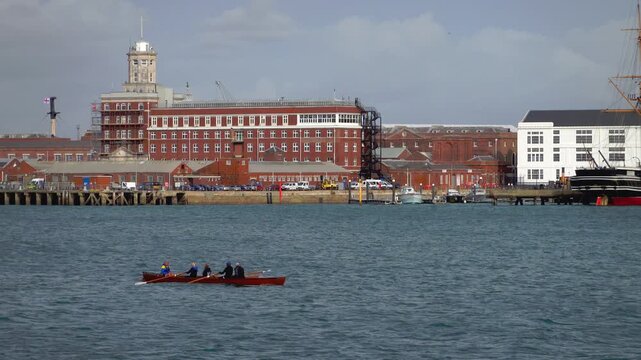 A rowing team in a wooden boat, Portsmouth harbour