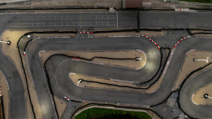 Aerial top view race kart track at night, Track for auto racing top view at night, Car race asphalt and curve street circuit, Aerial view asphalt race track at night.