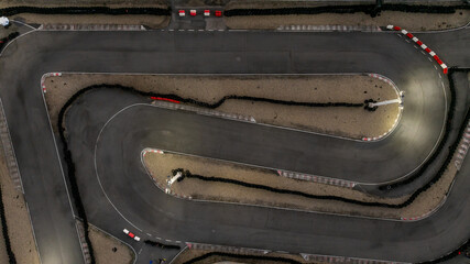 Aerial top view race kart track at night, Track for auto racing top view at night, Car race asphalt and curve street circuit, Aerial view asphalt race track at night.