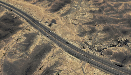 Lonely Highway: Aerial View of a Desert Road Cutting Through Saudi Arabia's Sands