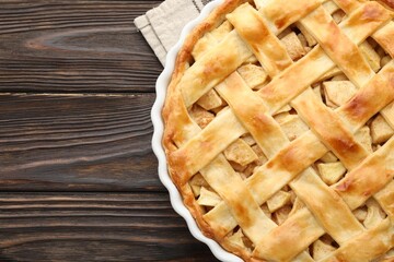 Tasty homemade apple pie on wooden table, top view. Space for text
