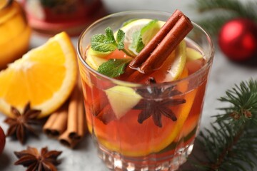 Tasty punch drink and spices on light table, closeup. Christmas season