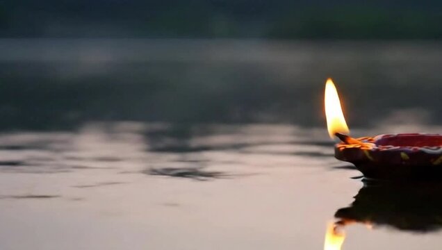 Clay Diya Lamp Floating on Water During Hindu Religious Ceremony