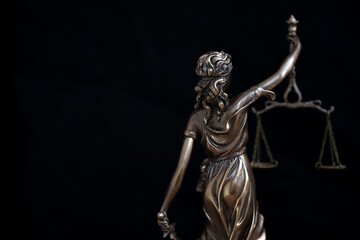 Lady Justice big statue in law on black backdrop. Law and justice concept