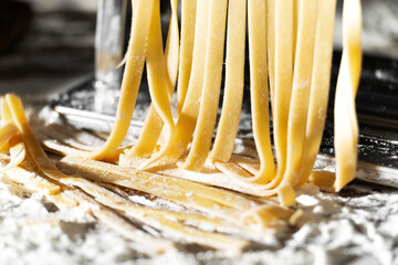 Fresh raw noodles made on home pasta machine closeup low angle view