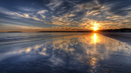 Peaceful beach landscape with vibrant sunset glow reflected on glossy wet sand, gentle waves in the background, soft cloud patterns in warm sky, calm coastal scene showing tranquil natural beauty
