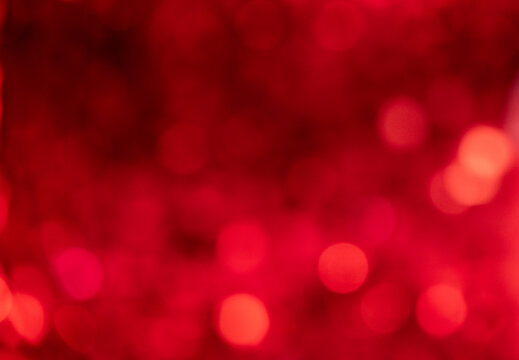 Soft red bokeh abstract background with glowing light circles and warm festive blur