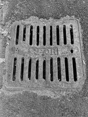 Rome, Italy - October 30, 2025, a cast iron manhole cover on the asphalt for water drainage with the S.P.Q.R. sign.