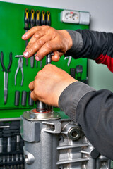 diesel engine fuel pump repair, installing camshaft in fuel pump mounted on workbench