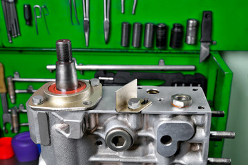 diesel engine fuel pump repair, installing camshaft in fuel pump mounted on workbench