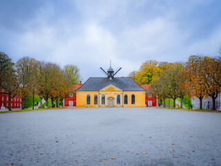 Kastelskirken at Kastellet, a Baroque citadel church framed by autumn trees under a moody sky in Copenhagen, Denmark—classic Nordic travel landmark and architecture icon.