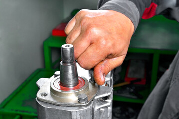 diesel engine fuel pump repair, installing camshaft in fuel pump mounted on workbench