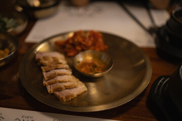 Authentic Korean Full Course Meal (Hansik Hansang) served on traditional Yugi Brassware with Banchan, Gyeran-jjim, and Main Dishes in a Rustic Dining Setting.