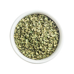 Dried chopped basil in white ceramic bowl Isolated transparent on white background