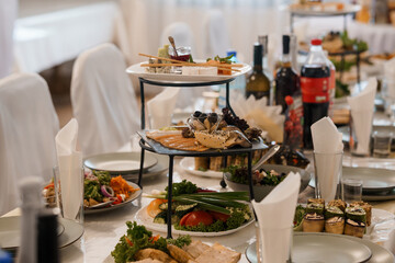 Elegant Catered Buffet Table with Assorted Appetizers, Fresh Vegetables, and Beverages at a Formal Event
