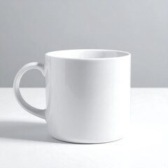 Obraz premium Simple White Ceramic Mug on White Surface with Gray Background.