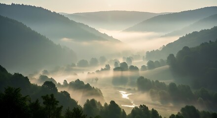 Obraz premium Misty Valley Landscape at Dawn with Rolling Hills and Trees.