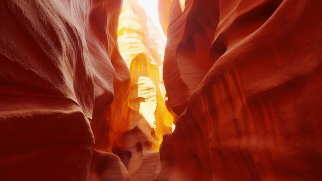 Discover the natural wonder of Antelope Canyon as warm sunlight illuminates the stunning red sandstone walls. Marvel at the intricate shapes and colors as the canyon glows at sunset