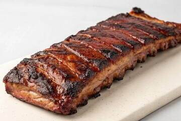 Delicious glazed pork ribs presented on a white serving platter appetizing
