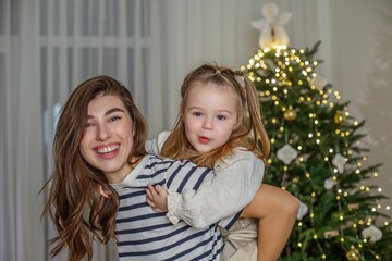 Close-up of happy mother and daughter at Christmas