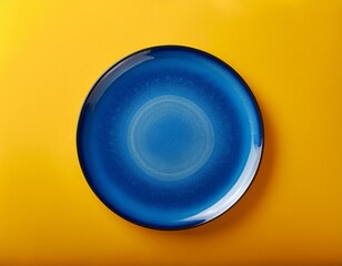 blue dinner plate on yellow with copy space