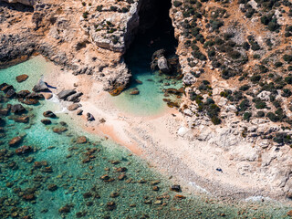 Aerial view shows Blue Lagoon cove on Comino Island, Malta. Shallow turquoise water meets pale...