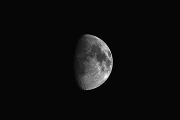 Stunning Half Moon in a Dark Night Sky with Visible Craters and Lunar Details.