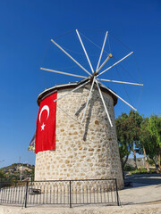 Iconic stone windmill of Ala&ccedil;atı with the Turkish flag