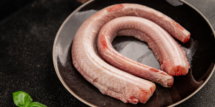 Raw rock eel fish rock salmon shark seafood small-spotted catshark tasty snack fresh delicious gourmet food background on the table rustic top view copy space pescetarian diet