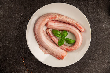 Raw rock eel fish rock salmon shark seafood small-spotted catshark tasty snack fresh delicious gourmet food background on the table rustic top view copy space pescetarian diet