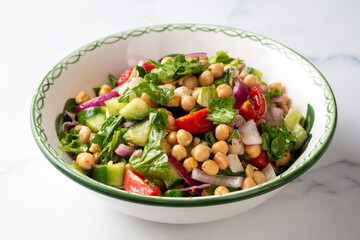 Vegetarian chickpea salad with tomatoes, arugula, parsley, spinach and red onion. Healthy food, diet. Top view
