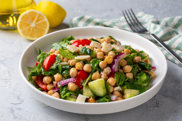Vegetarian chickpea salad with tomatoes, arugula, parsley, spinach and red onion. Healthy food, diet. Top view