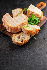 Washed rind cheese soft cheese with orange rind munster french cheese tasty snack fresh delicious gourmet food background on the table rustic top view copy space