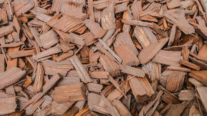 Top view of light wooden chips background for gardening or landscaping. High quality photoHorizontal macro top view of large light wooden chips. Natural wood texture used for gardening, landscaping